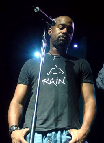 A picture of Darius Rucker standing in front of a microphone.