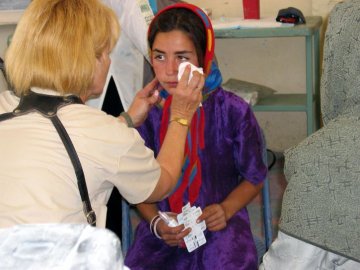 A picture of a healthcare worker tending a patient.